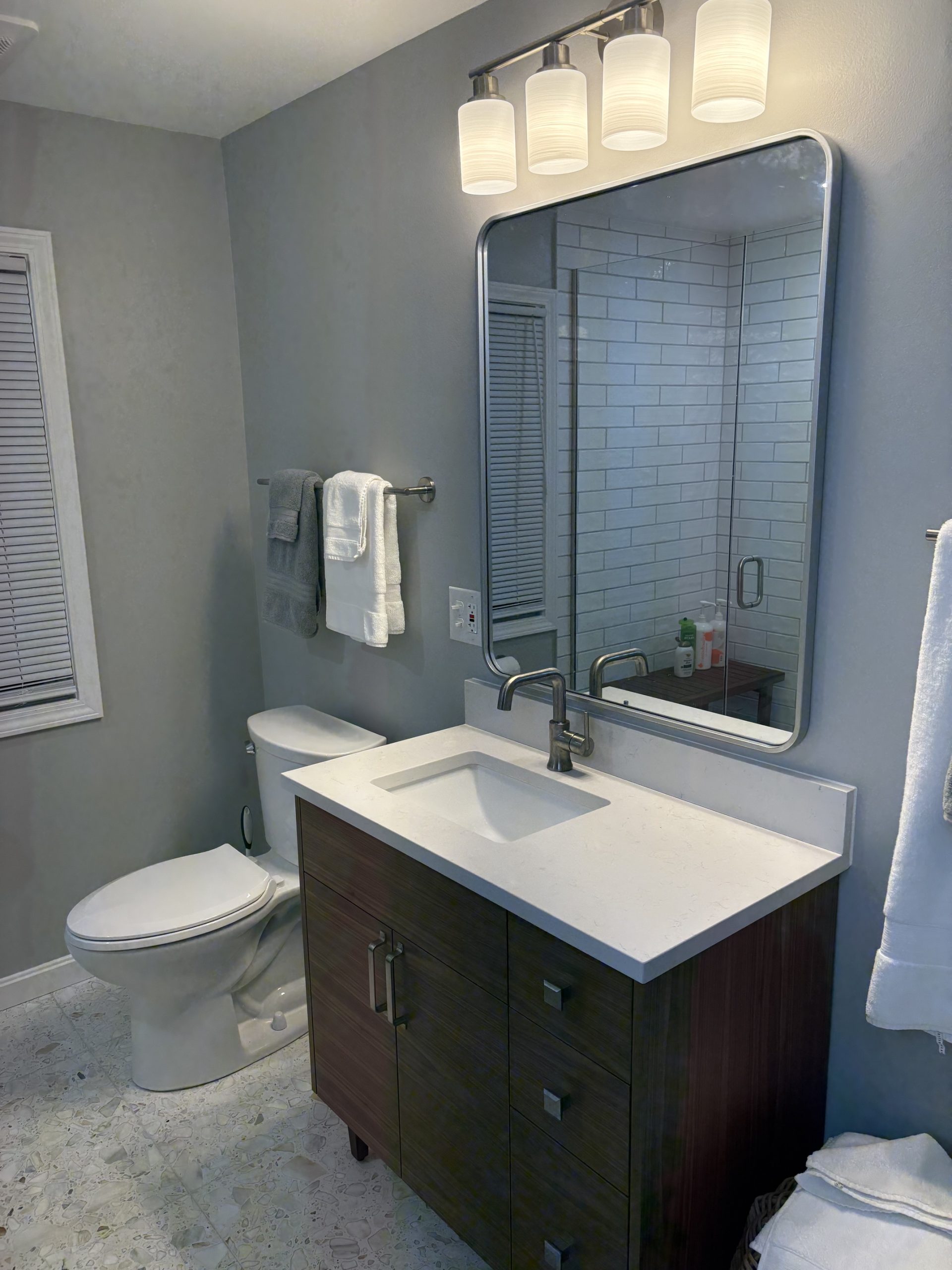Completed Shaker Heights bathroom vanity with quartz countertop and mirror