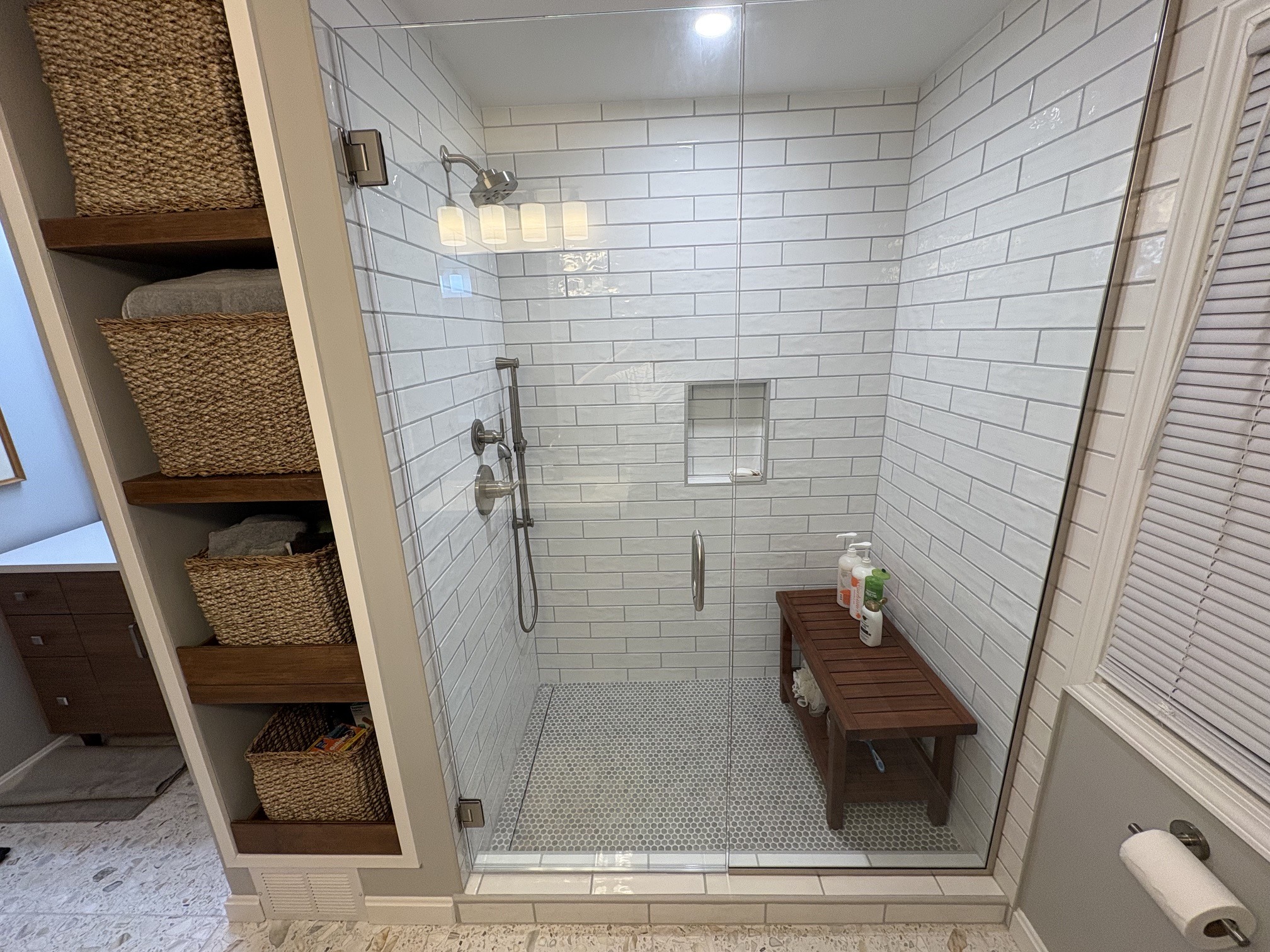 Wide view of Shaker Heights glass shower and storage shelves