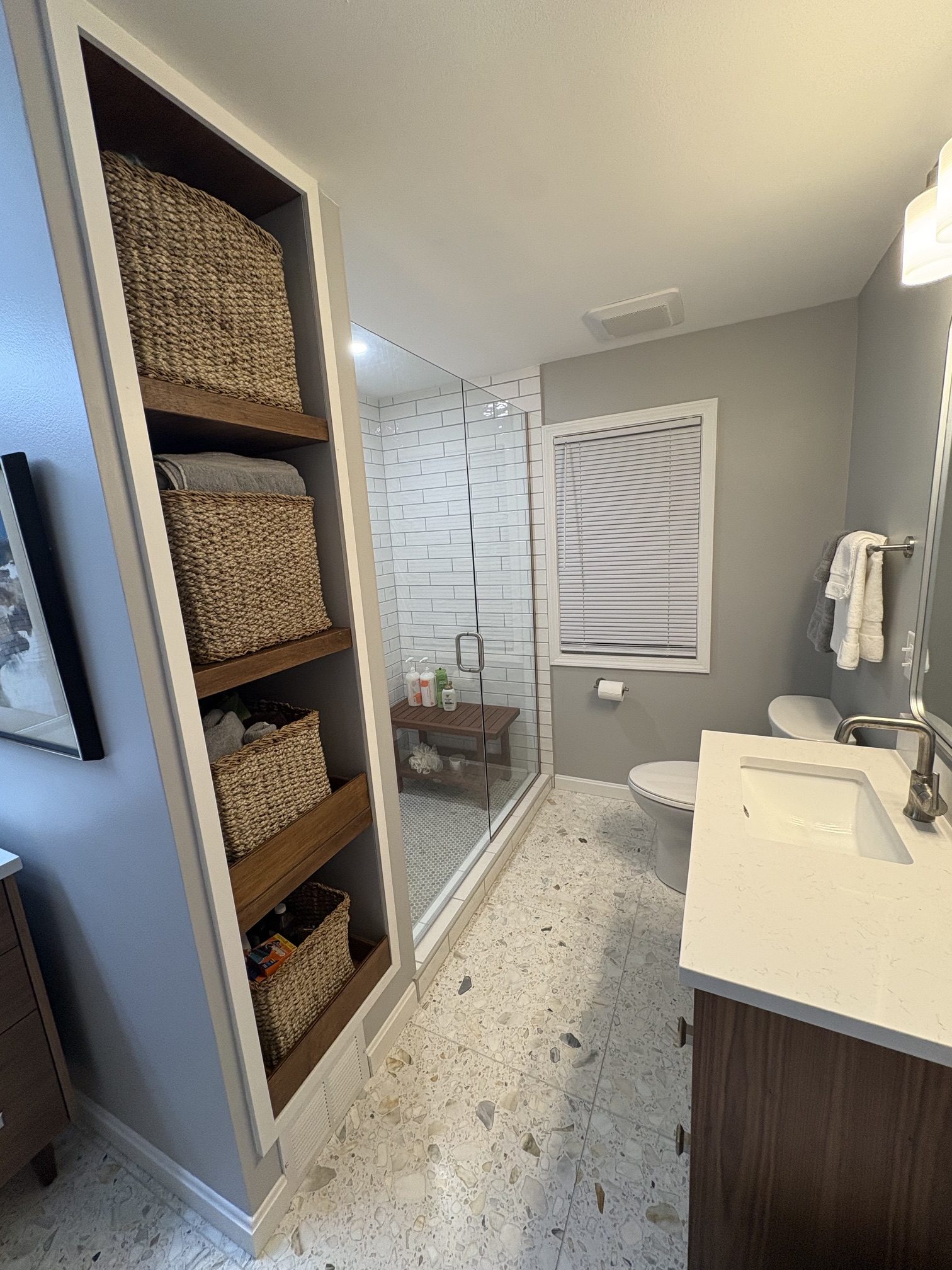 Completed Shaker Heights bathroom with shower, vanity and storage