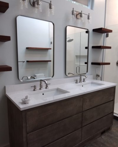 Chagrin Falls bathroom after renovation, double sink vanity and wood shelves